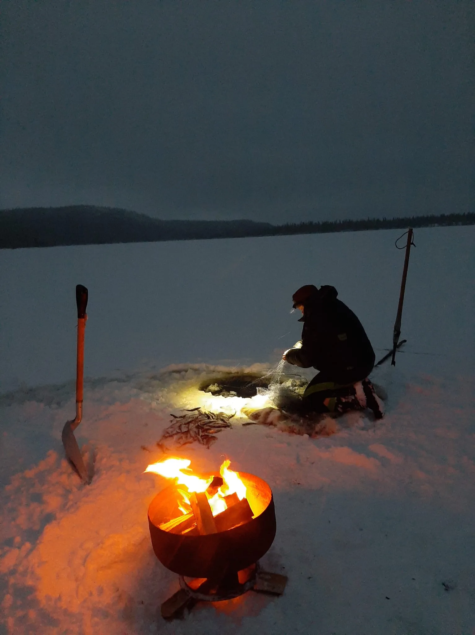 Mika ice fishing at dusk